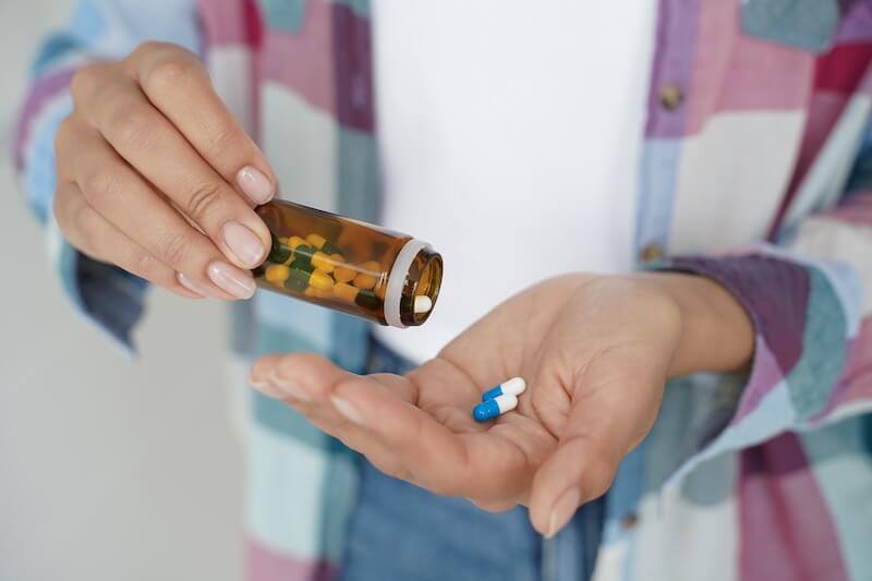 close-up-female-hands-holding-pills